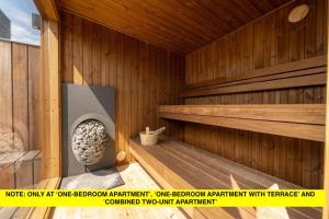 an inside of a wooden sauna with a stone at Nørrebrogade 209 in Copenhagen