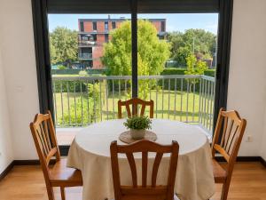 a dining room table with chairs and a large window at El jardín de Cirueña in Cirueña
