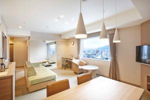 a living room with a view of a city at Tokyu Vacations Sapporo in Sapporo
