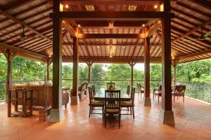a pavilion with a table and chairs on a patio at Villa Beji Mawang Ubud by GenuineHost in Ubud