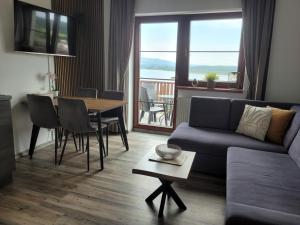 a living room with a couch and a table at Apartmán Kovadlina 5 - Kovářov, výhled na Lipno in Frymburk