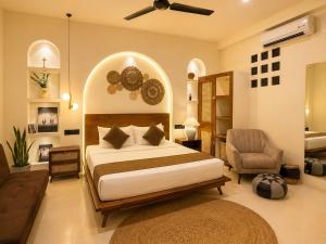 a bedroom with a large bed and a chair at The Neylipz - Fully Air Conditioned 3 bedroom Apartment in Weligama +44 photos