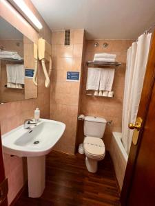a bathroom with a white sink and a toilet at Alda A Boira in Jaca +38 photos