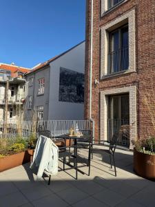 a patio with a table and chairs on a building at Aura Apartment Hotel in Aarhus +35 photos