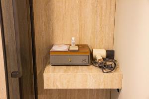 a room with a table with a radio on a wall at Boutique Hotel 19D in Almaty +18 photos