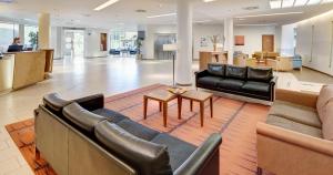 a lobby with couches and chairs and a table at Sercotel Valladolid in Valladolid +169 photos