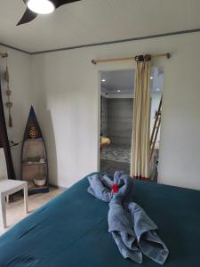 ein Bett mit einem Stapel Handtücher darauf in der Unterkunft Te Ava Piti Lodge in Uturoa