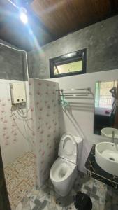 a bathroom with a toilet and a sink at Love Loft Homestay in Ban Pilok Khi