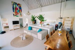 a living room with a table and a couch at Luxury 3-Bedroom Villa with Private Pool in Pulukan