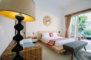 a bedroom with a bed and a chair and a lamp at Luxury 3-Bedroom Villa with Private Pool in Pulukan +37 photos