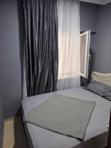 a bed in a bedroom with a window at Ören örtur tatil evleri in Ören