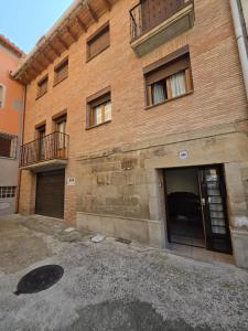a large brick building with two garage doors at Apartamento Ioar in Los Arcos
