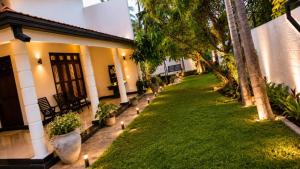 a house with a lawn in front of it at CeylonAirbnb in Puttalam