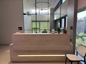 an office lobby with a reception desk with two chairs at Collection O Airport Road Formerly Hotel Nano Pod in Surat