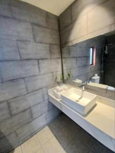 a bathroom with a sink and a mirror at Kampot Tropical Resort 
