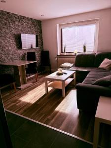 a living room with a couch and a table at Apartmenthaus Schlanow in Detmold