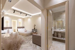 a living room with a couch and a bathroom with a sink at Premium Pyramids BoutiQue With Rooftop Access in Cairo