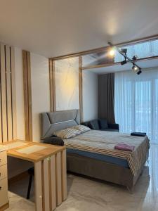 a bedroom with a bed and a couch in it at Azur properties 22 in Shkorpilovtsi +9 photos