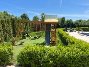 a playground in a garden with a swing at Azur properties 22 in Shkorpilovtsi
