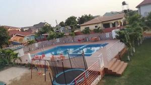 a swimming pool with a slide in a house at Mr smith hotel in Accra