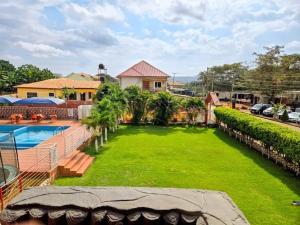 a house with a large yard with a swimming pool at Mr smith hotel in Accra
