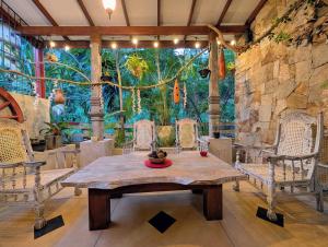 a dining room with a table and chairs and a mural at Gangula Villa in Kandy