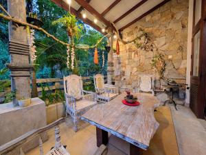 a patio with a wooden table and chairs at Gangula Villa in Kandy