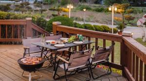 a table and chairs on a deck with food on it at Taean Ocean Stay Pension in Taean