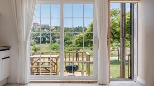 an open door to a balcony with a view at Taean Ocean Stay Pension in Taean