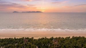 a sunset over the ocean with a sandy beach at Taean Ocean Stay Pension in Taean +4 photos