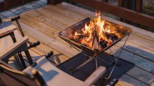 a grill sitting on a deck next to a chair at Taean Ocean Stay Pension in Taean