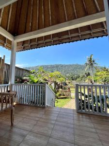 an outdoor deck with a view of the mountains at Bali Dreams Bungalows in Tenganan