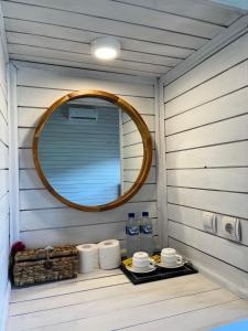 a bathroom with a mirror and a tray with toiletries at Bali Dreams Bungalows in Tenganan