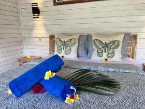 a bed with butterfly pillows on top of it at Bali Dreams Bungalows in Tenganan