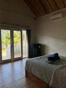 a bedroom with a bed with a blue bag on it at Bali Dreams Bungalows in Tenganan +16 photos