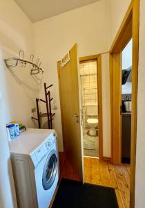 a washer and dryer in a room with a bathroom at Gästehaus Schiffmann 1895 in Brauneberg +70 photos