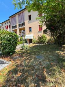 a building with a large yard in front of it at Peperoncino Home in Pedeguarda