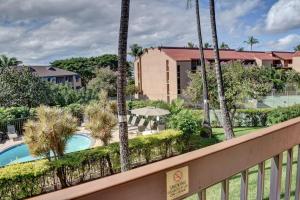 a balcony with a view of a pool and palm trees at Maui Vista 2207 in Kihei