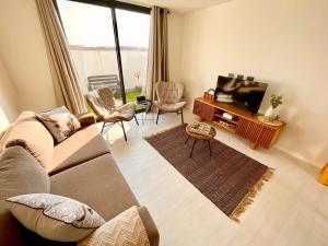 a living room with a couch and a flat screen tv at 42 on Kavango Unit 24 in Swakopmund