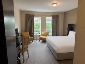 a hotel room with a bed and a table and chairs at Wilton Hotel Bray in Bray +14 photos