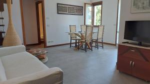 a living room with a couch and a tv and a table at Santarcangelo Stay Your Perfect Base in Romagna in Santarcangelo di Romagna