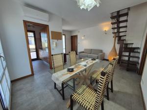 a living room with a dining table and chairs at Santarcangelo Stay Your Perfect Base in Romagna in Santarcangelo di Romagna