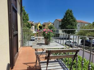 a balcony with a wooden table with a potted plant at Santarcangelo Stay Your Perfect Base in Romagna in Santarcangelo di Romagna