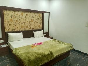 a bedroom with a bed with a flower on it at Hotel Gungun Jawai, Sumerpur in Sheoganj