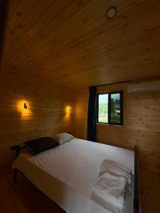 a large bed in a wooden room with a window at Villa cottage D3 in Zeda Ulianovka +41 photos