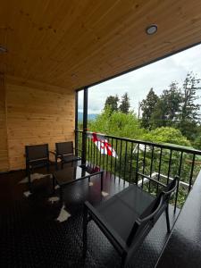 a room with two chairs and a table on a balcony at Villa cottage D3 in Zeda Ulianovka