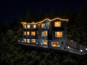 a large building with lights on it at night at The Elena Dogri Homes, A Comfortable & Luxury Stay - Best Selling Cottage 2025-26 in Shimla
