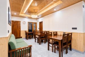 a dining room with wooden tables and chairs at The Elena Dogri Homes, A Comfortable & Luxury Stay - Best Selling Cottage 2025-26 in Shimla