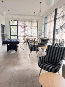 a room with couches and a pool table and tables at Penzión Alma in Poprad +33 photos