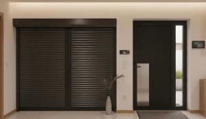 a large garage door in a house with a plant at Casa Machado in Cabeceiras de Basto +3 photos